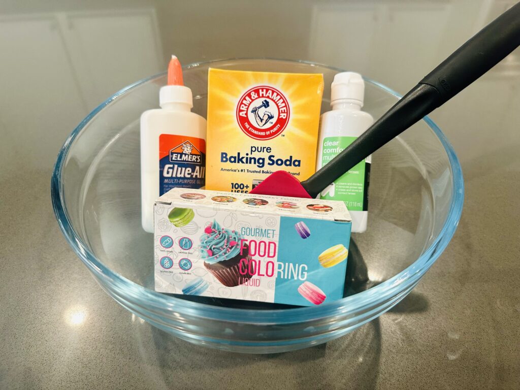 Ingredients to make homemade slime sitting in a mixing bowl.