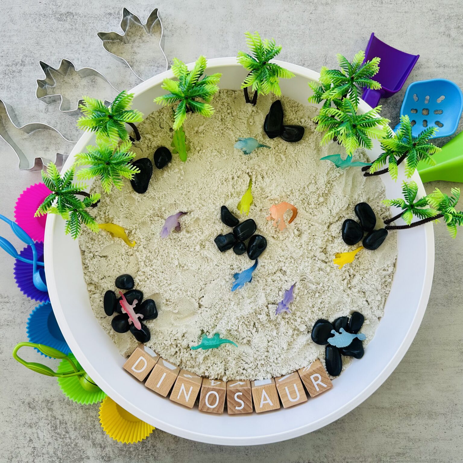Dinosaur Sensory Bin Using DIY Kinetic Sand - Raising Wild Things Sensory