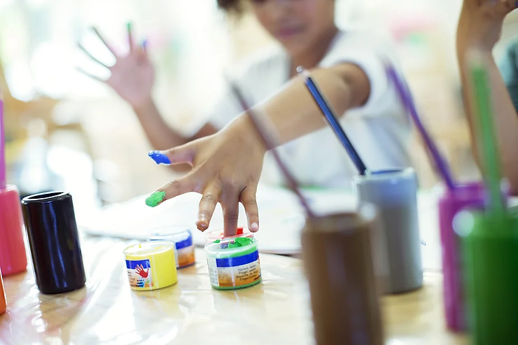 Child finger painting.