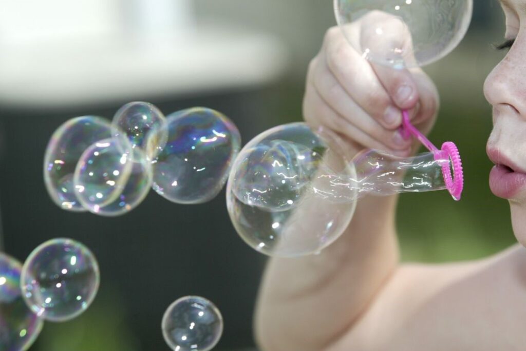 Child blowing bubbles.