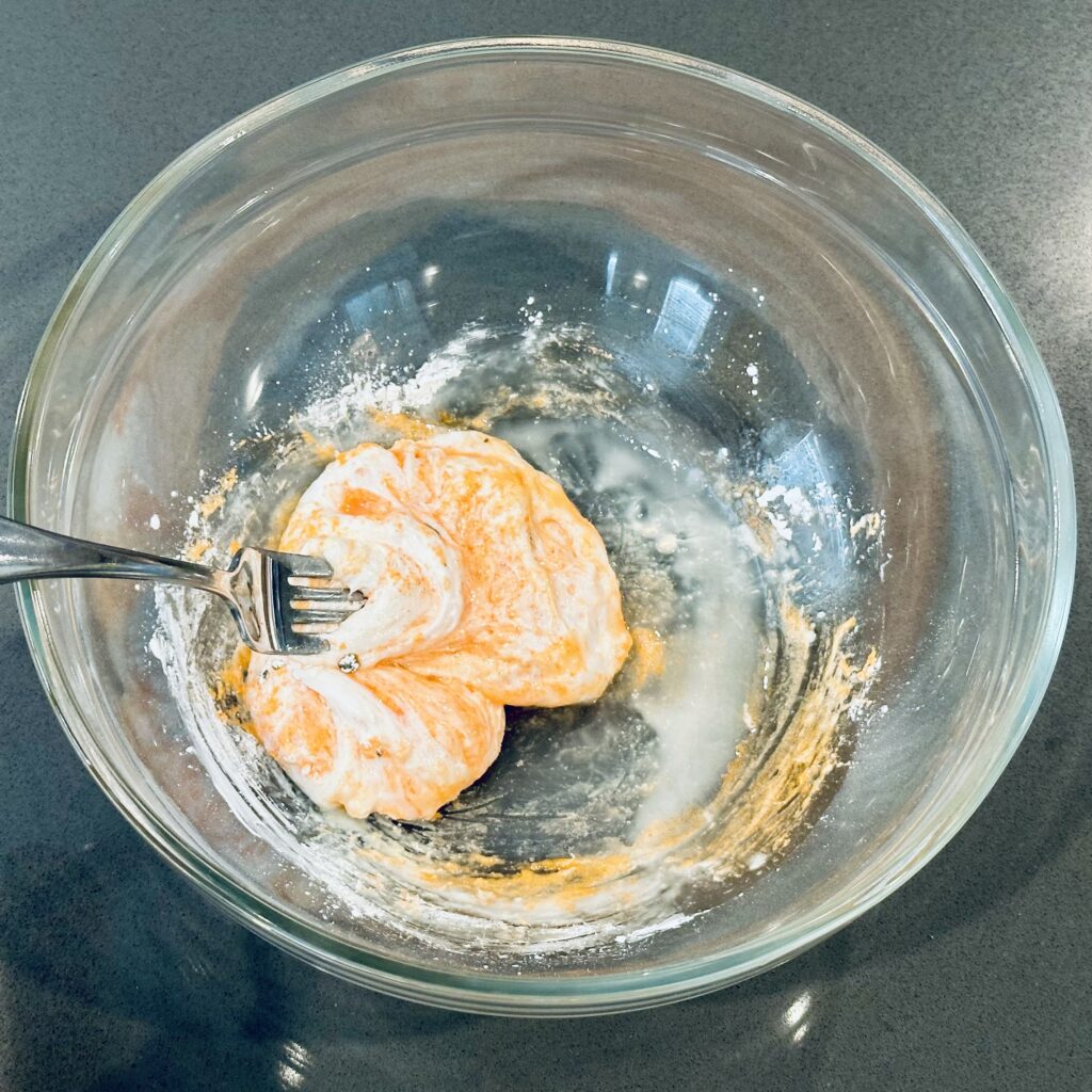 Mixing melted pumpkin peeps, oil, and cornstarch together in a mixing bowl