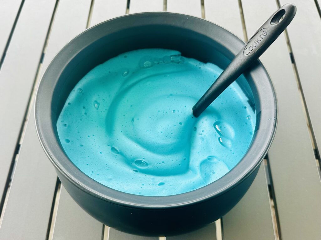 Colored bubble foam in a cauldron bowl for sensory play.