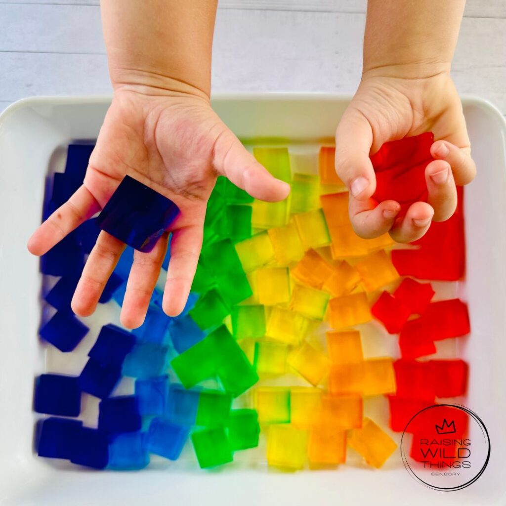 Kid's hands holding a single jello block.