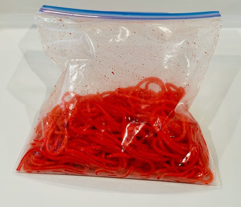 Food dye setting on the pasta noodles in a Ziplock bag.