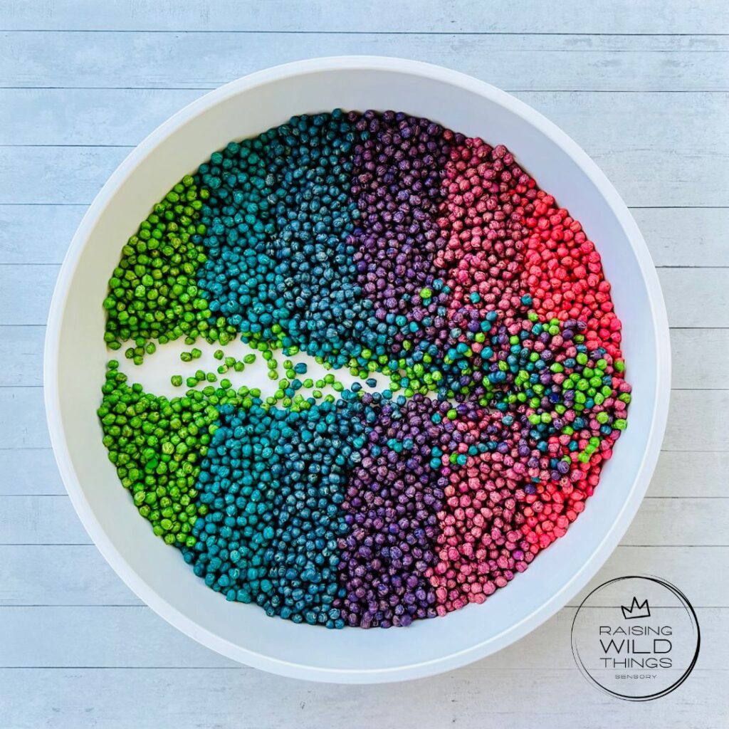 Rainbow chickpeas in a sensory bin