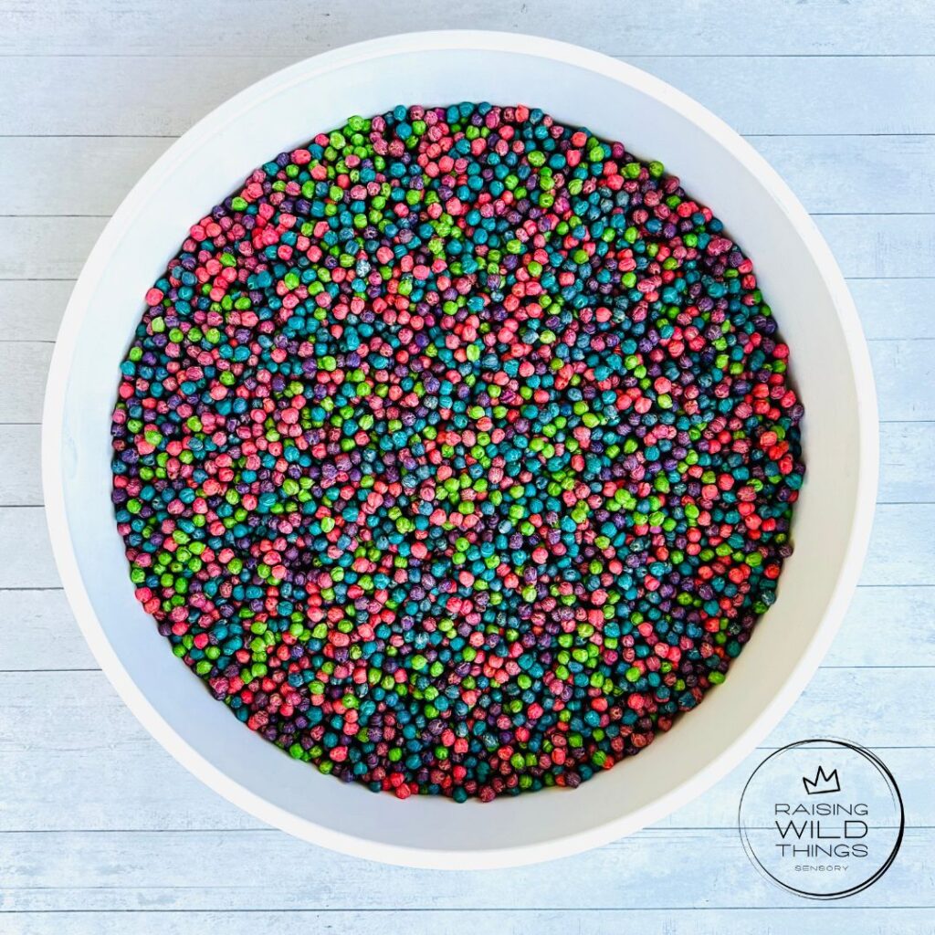 Rainbow chickpeas in a sensory bin