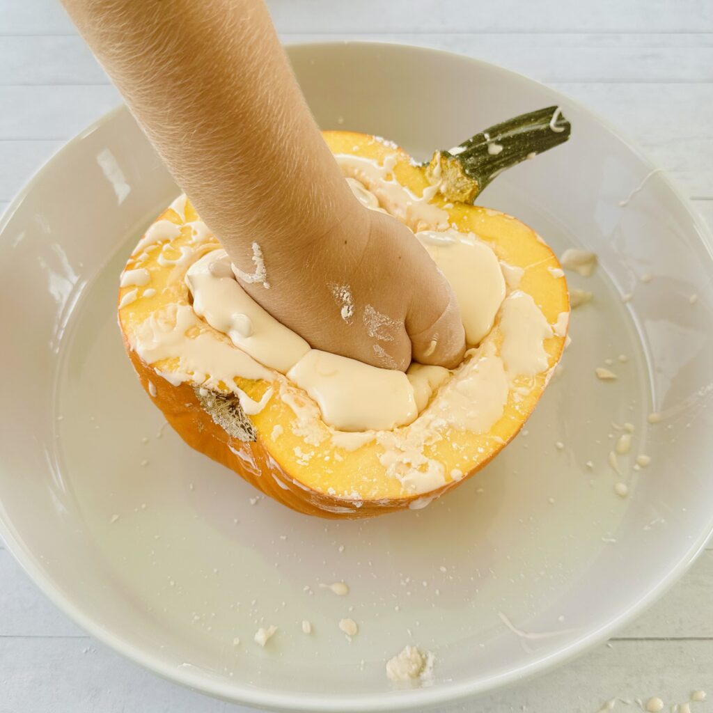 Child's hand playing with Pumpkin Oolbeck