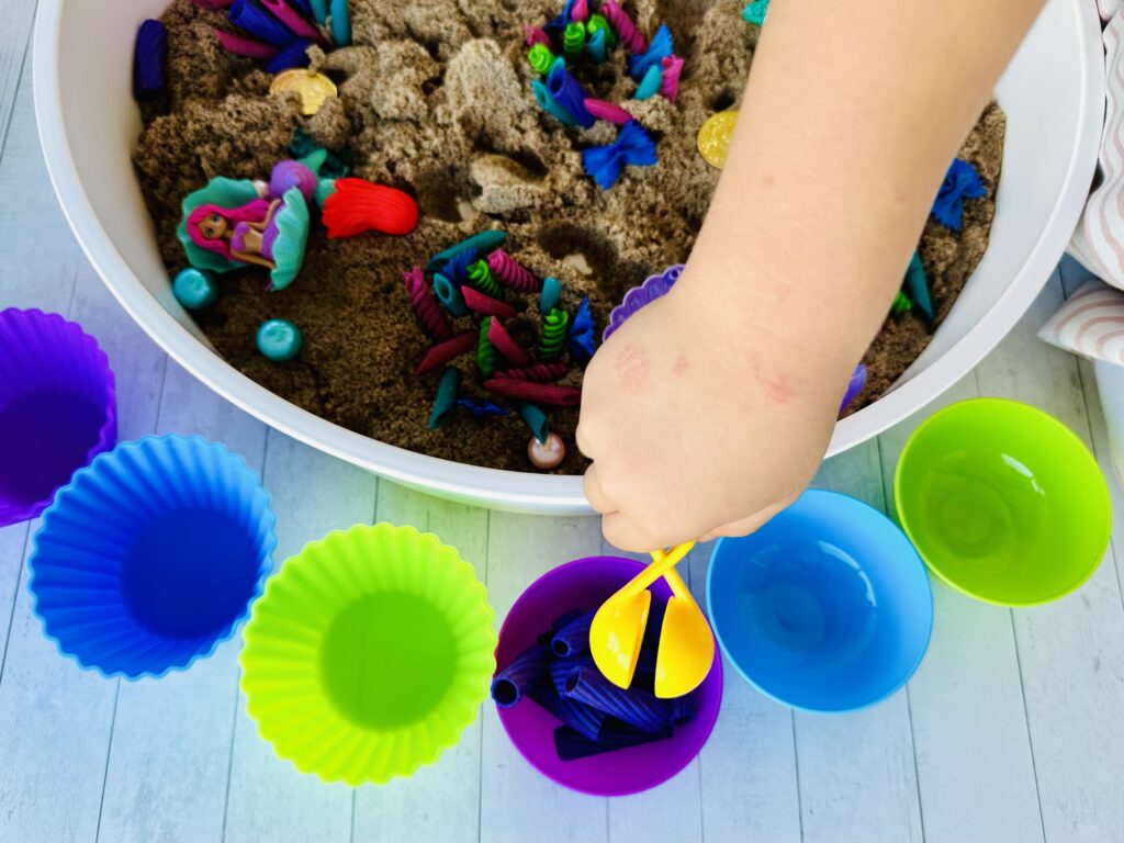 Kids digging through the mermaid sensory bin