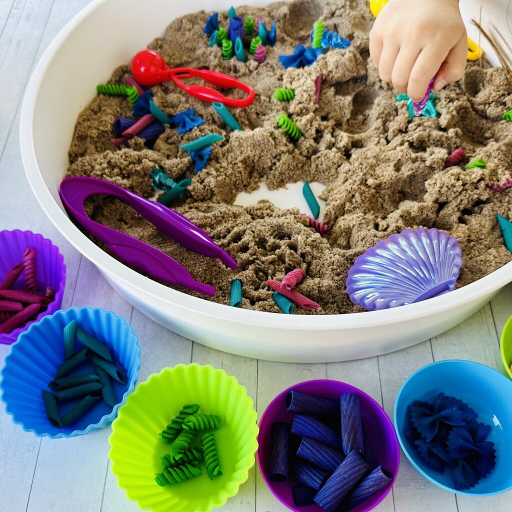 Kids digging through the mermaid sensory bin