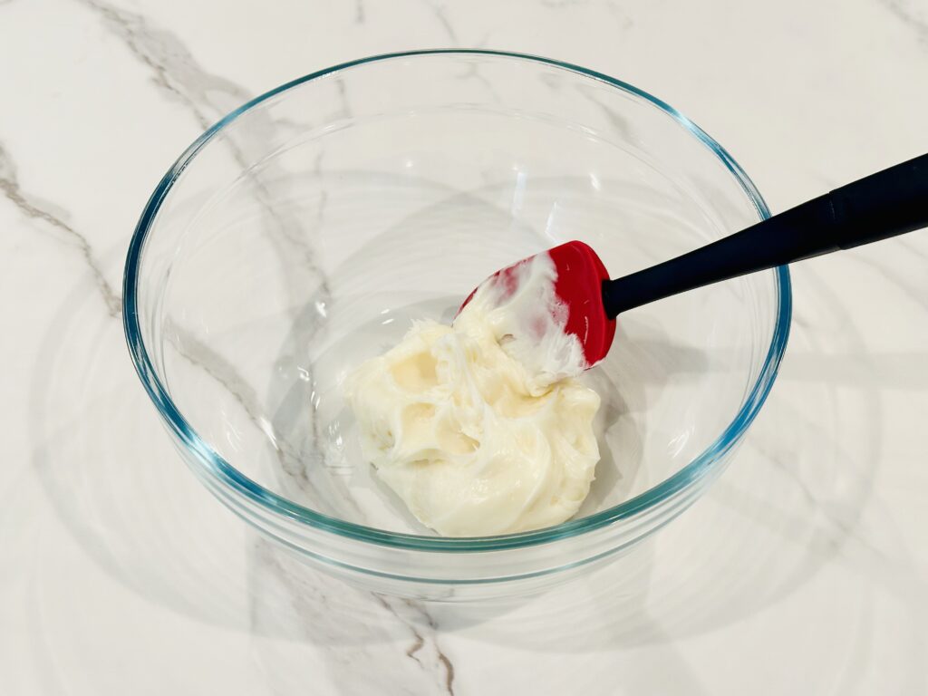 Frosting added to a mixing bowl