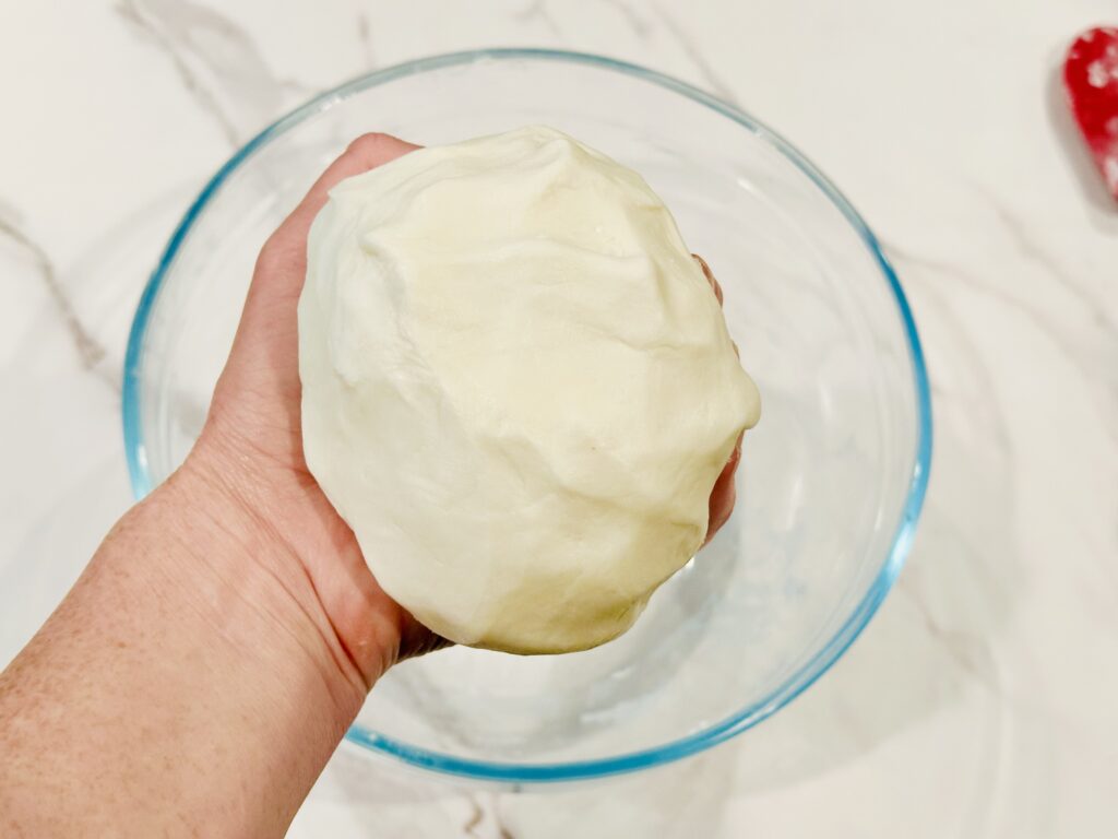 Kneading the edible play dough by hand