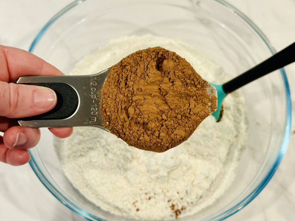 Mixing cocoa powder and flour in a mixing bowl 