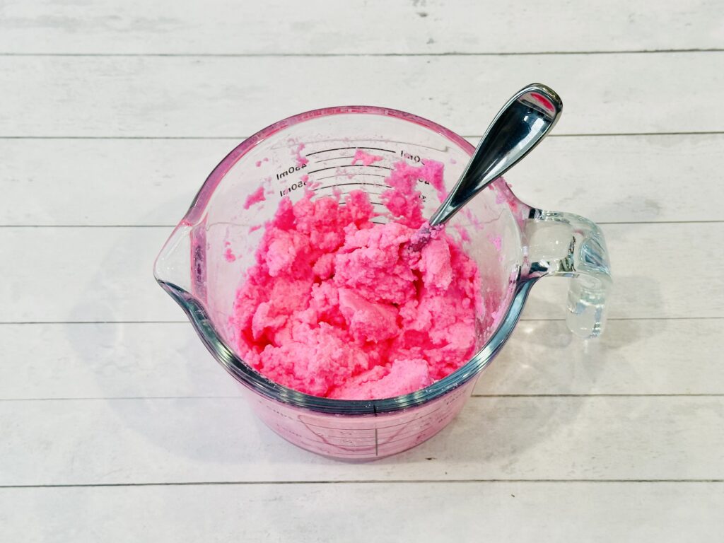 Colored water mixed into the baking soda and gelatin mixure to make Valentine's Day Fizzy Heart Ice Cubes