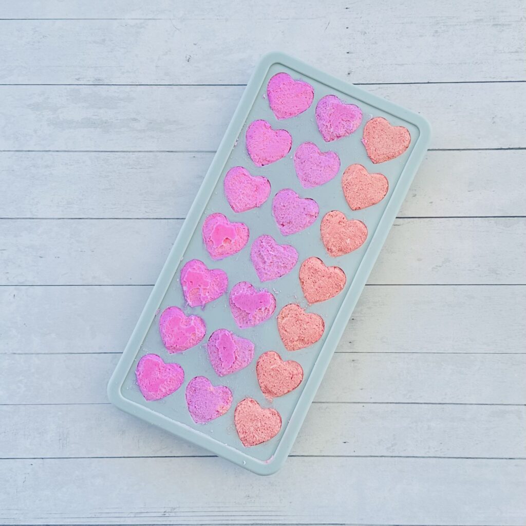 Mixture spooned into heart ice cube tray to make Valentine's Day Fizzy Heart Ice Cubes