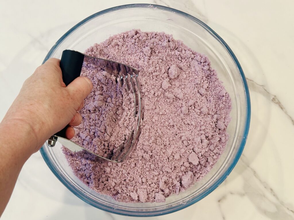 Using a pastry cutter to work the oil and food coloring into the dough