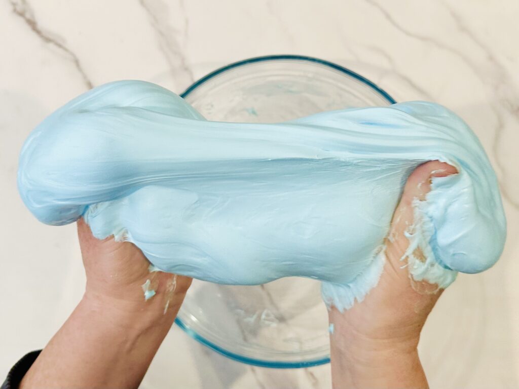 Kneading the fluffy slime with hands.