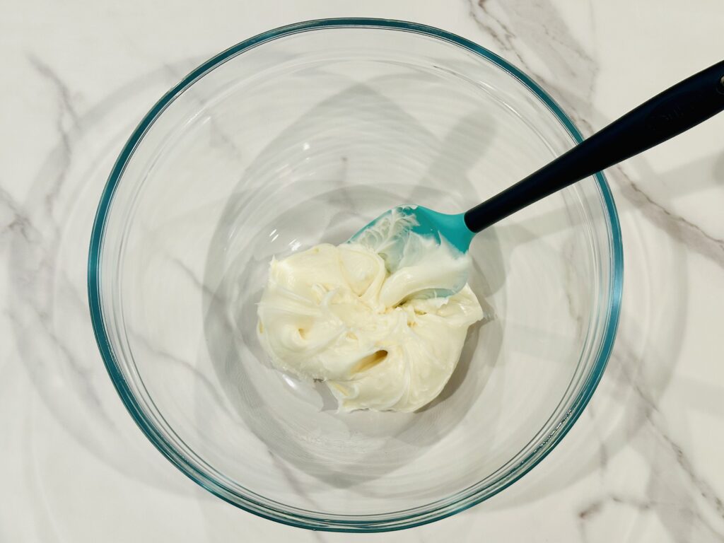 Frosting added to a mixing bowl