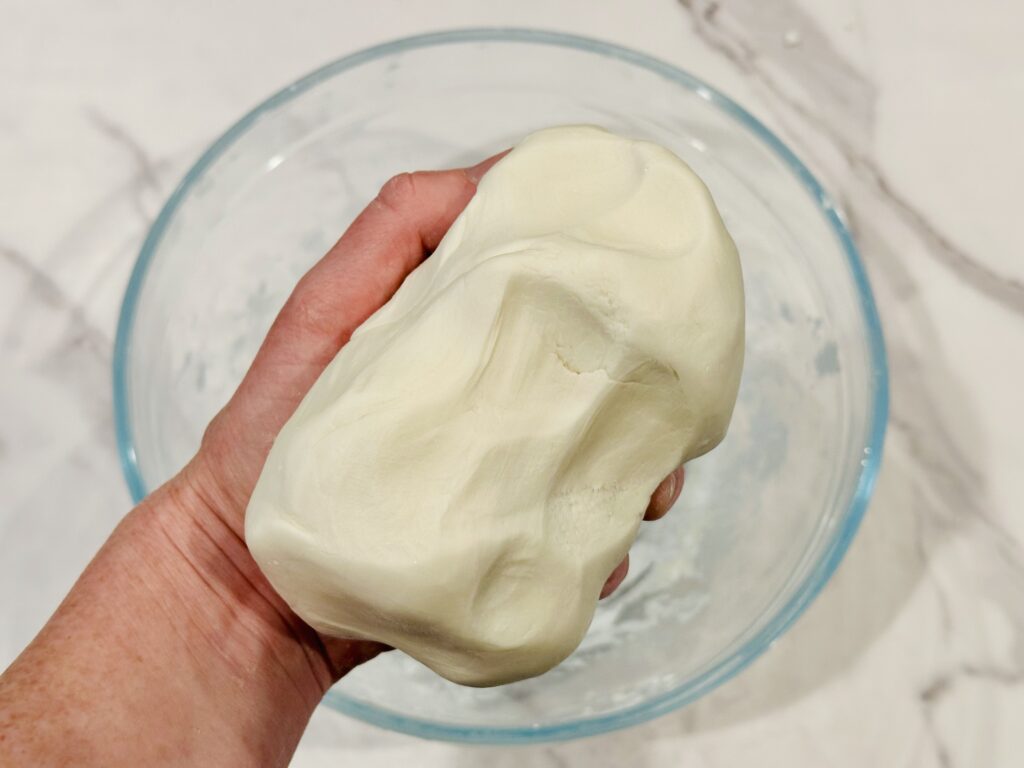 Kneading the St. Patrick’s Day edible play dough by hand