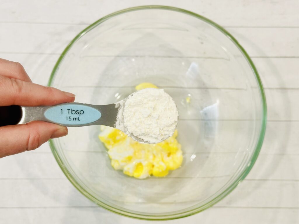 Adding corn starch to the melted Easter Peeps and oil mixture