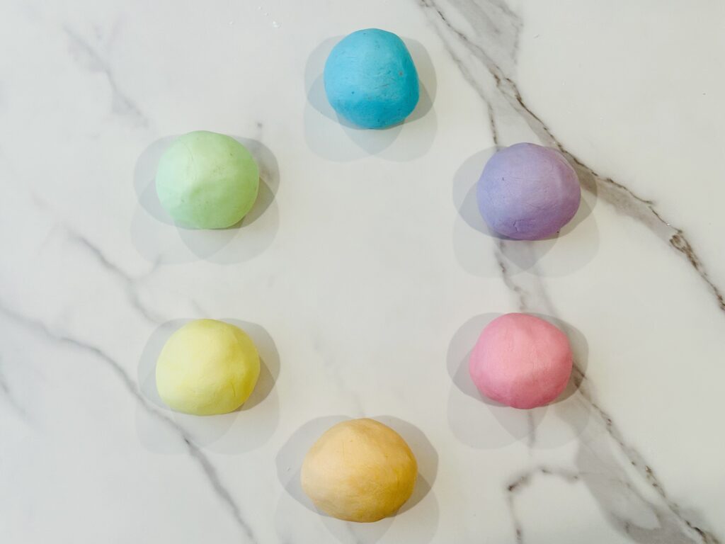 Adding food coloring to the Edible Easter Playdough