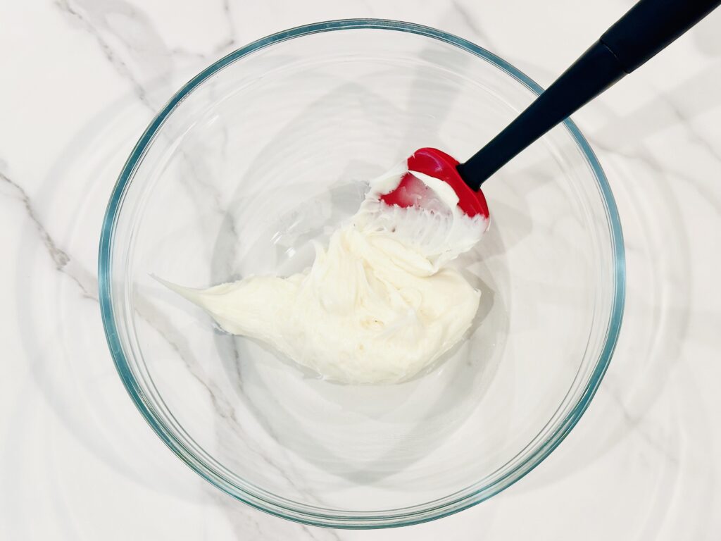 Frosting added to a mixing bowl