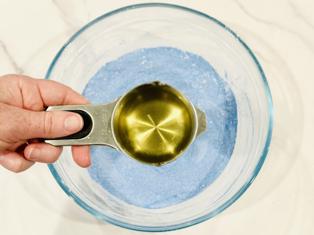 Oil added to fine play sand and cornstarch in a mixing bowl