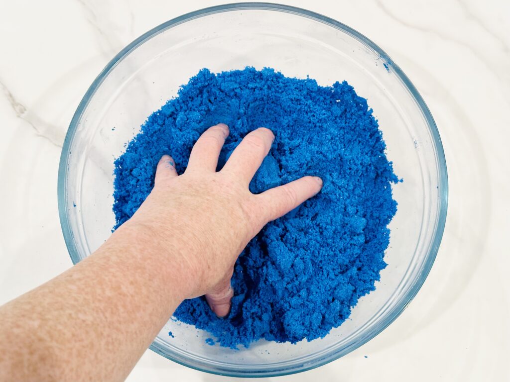 Kneading the kinetic sand with hands