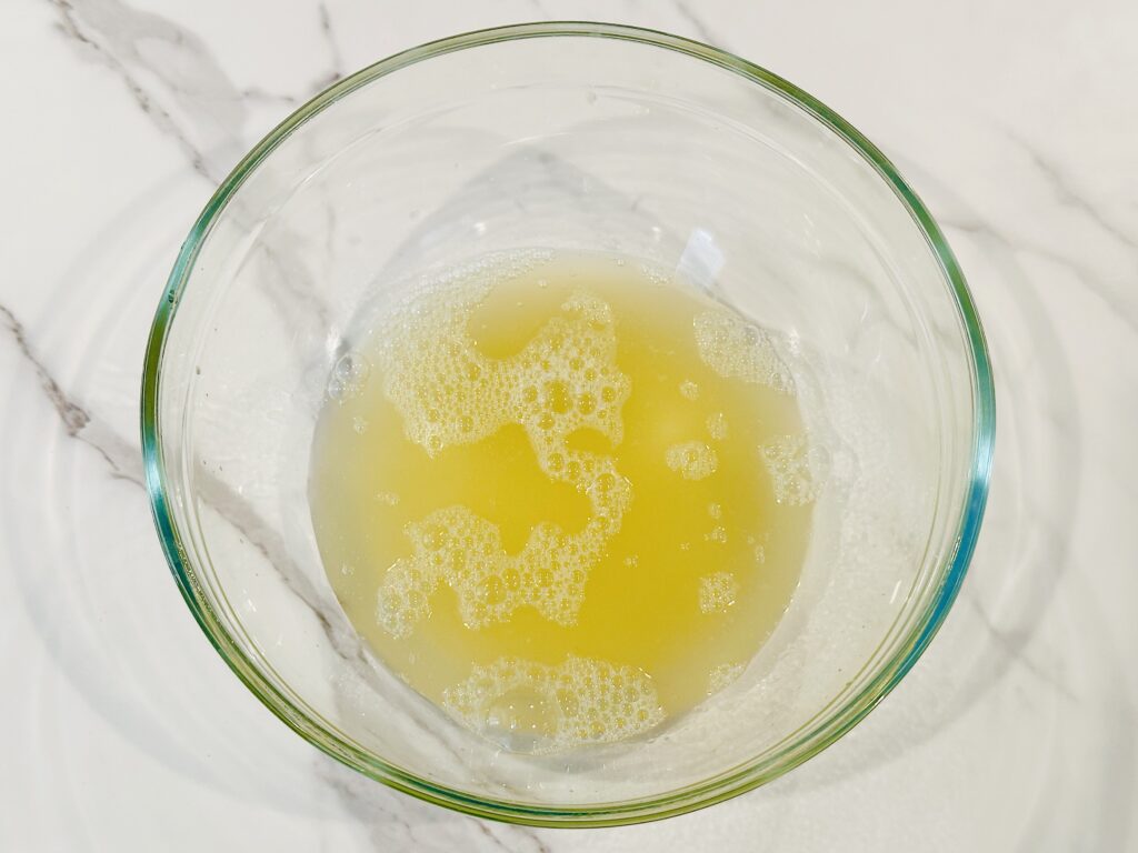 Chickpea liquid poured into a mixing bowl