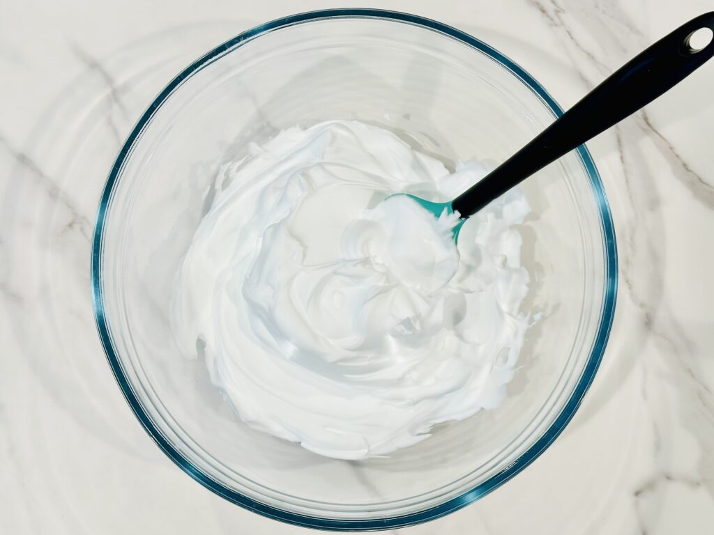Adding shaving cream to a mixing bowl