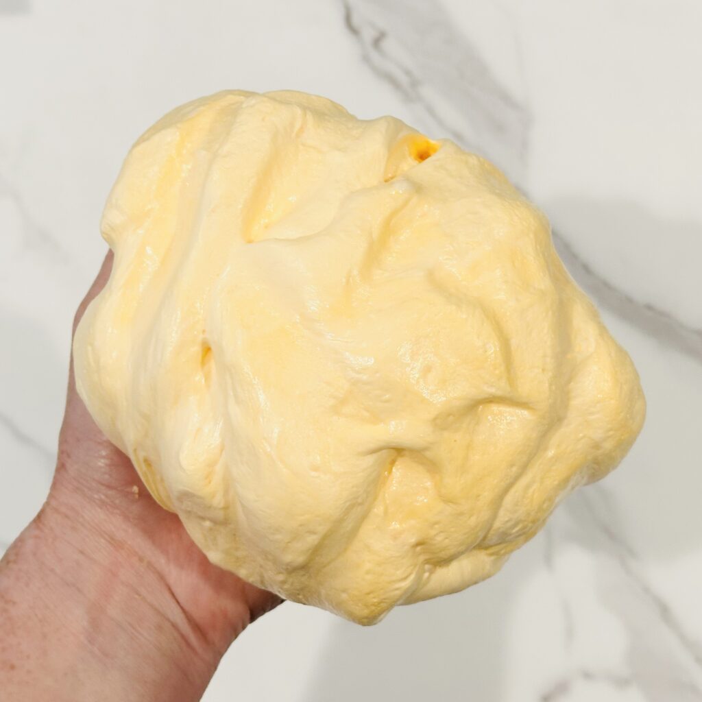 Kneading the fluffy slime with hands.