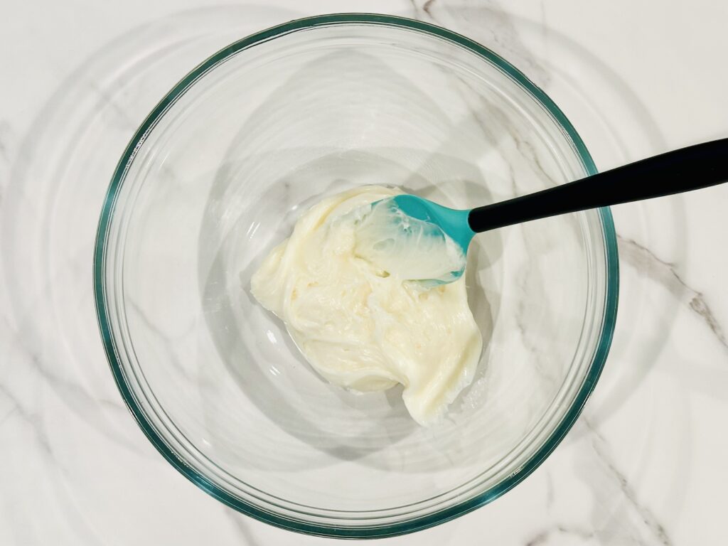 Frosting added to a mixing bowl